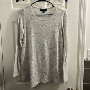 Women’s light grey size small shirt with black stars and small slit on side